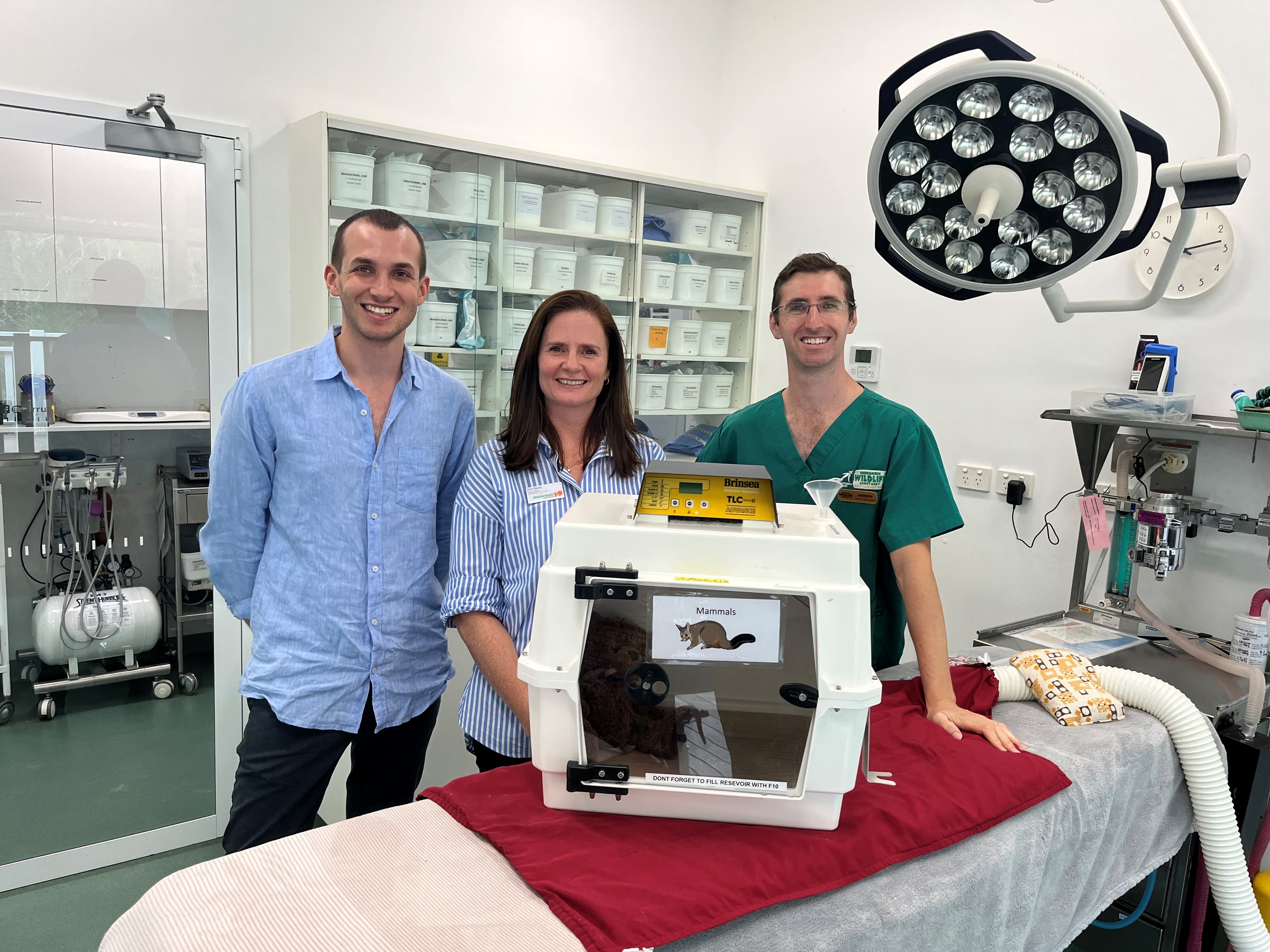 Andrew, Julien and Erin standing in front of the donated humidifier. 